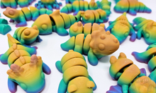 Load image into Gallery viewer, An array of 3D printed fidget animals with colorful rainbow finishes, displaying different articulated designs.