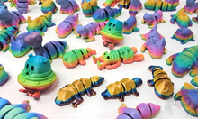Load image into Gallery viewer, Assorted 3D printed stress relief animals in glossy, matte, and silk rainbow finishes, including creatures like lizards, bunnies, and space creatures, shown together.