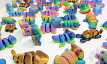 Load image into Gallery viewer, An array of 3D printed fidget animals with colorful rainbow finishes, displaying different articulated designs.