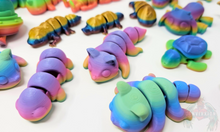 Load image into Gallery viewer, An array of 3D printed fidget animals with colorful rainbow finishes, displaying different articulated designs.