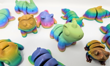 Load image into Gallery viewer, An array of 3D printed fidget animals with colorful rainbow finishes, displaying different articulated designs.