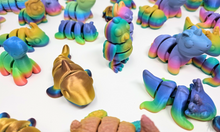 Load image into Gallery viewer, A variety of 3D printed fidget animals in various rainbow finishes, featuring detailed and articulated designs such as dragons, axolotls, pigs, bees, brontos, and turkeys, placed on a plain background.