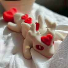 Load image into Gallery viewer, Valentine Love Dragon mini articulated figure lying on a soft white fabric, showcasing its white body and vibrant red heart accents on the head, back, and tail. Perfect for stress relief, fidgeting, or as a charming Valentine's gift. Photographed in natural lighting for a cozy and inviting look.