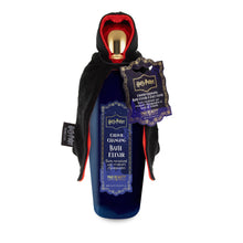 Load image into Gallery viewer, Harry Potter color changing bath elixir by Mad Beauty, in a dark blue bottle with a gold cap dressed in a black hooded cloak with red lining and a decorative hang tag, shown on a white background.