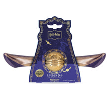 Load image into Gallery viewer, Harry Potter Golden Snitch lip balm duo by Mad Beauty, shown in purple wing-shaped packaging with a gold Snitch-shaped balm in the center on a white background.