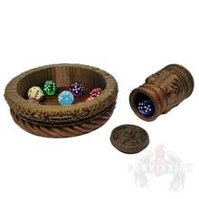 Load image into Gallery viewer, Pirate themed dice cup and tray set with a dark metallic gradient, lying on its side with a die spilling out. Several dice rest inside the matching tray, showcasing the set’s intricate design and perfect fit for tabletop gaming.