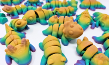 Load image into Gallery viewer, An array of 3D printed fidget animals with colorful rainbow finishes, displaying different articulated designs.
