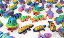 Load image into Gallery viewer, Assorted 3D printed stress relief animals in glossy, matte, and silk rainbow finishes, including creatures like lizards, bunnies, and space creatures, shown together.
