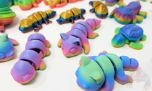 Load image into Gallery viewer, An array of 3D printed fidget animals with colorful rainbow finishes, displaying different articulated designs.
