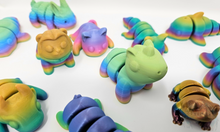 Load image into Gallery viewer, An array of 3D printed fidget animals with colorful rainbow finishes, displaying different articulated designs.
