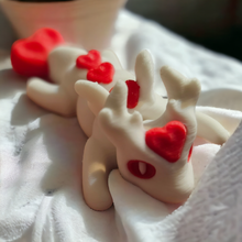 Load image into Gallery viewer, Valentine Love Dragon mini articulated figure lying on a soft white fabric, showcasing its white body and vibrant red heart accents on the head, back, and tail. Perfect for stress relief, fidgeting, or as a charming Valentine&#39;s gift. Photographed in natural lighting for a cozy and inviting look.
