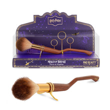 Load image into Gallery viewer, Harry Potter broom-shaped makeup brush by Mad Beauty shown in a purple Hogwarts-themed display stand and separately on a white background, featuring a curved wood-effect handle, gold detailing, and soft fluffy bristles, collectible cosmetic brush for Harry Potter fans and makeup gift sets.
