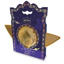Load image into Gallery viewer, Harry Potter Golden Snitch pop-up brush and mirror set by Mad Beauty, shown closed inside purple Hogwarts-themed packaging with the gold winged compact visible through a round window on a white background.
