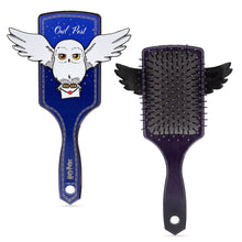 Load image into Gallery viewer, Harry Potter Hedwig “Owl Post” hair brush by Mad Beauty, shown from the front with Hedwig flying and holding a letter, and from the back with black wing-shaped details and bristles, on a white background.
