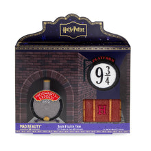Load image into Gallery viewer, Harry Potter Platform 9 3/4 bath fizzer trio by Mad Beauty, shown in brick tunnel–themed gift box packaging with three bath fizzers visible through the window: the Hogwarts Express front, a Platform 9 3/4 sign, and a Hogwarts trunk with an “H” on the front.
