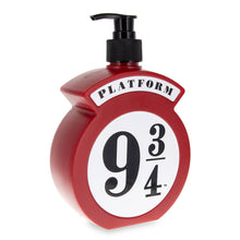 Load image into Gallery viewer, Angled view of the Harry Potter Platform 9 3/4 hand and body wash by Mad Beauty, in a red pump bottle shaped like the Platform 9 3/4 sign with a white circular label and black pump on a white background.
