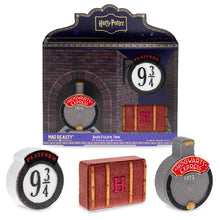 Load image into Gallery viewer, Harry Potter Platform 9¾ bath fizzer trio by Mad Beauty, with brick-themed gift box packaging and three bath fizzers shaped like the Platform 9¾ sign, a Hogwarts trunk with an “H,” and the Hogwarts Express front, shown on a white background.

