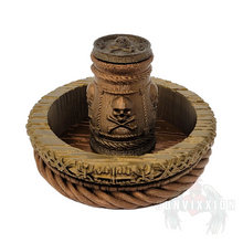 Load image into Gallery viewer, Front view of a pirate-themed dice cup and tray set, featuring a dark metallic gradient with rich gold and copper tones. The dice cup sits inside the matching tray, both designed with intricate details perfect for tabletop gaming.
